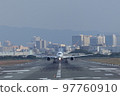 Front view of an airplane taking off from the runway 97760910