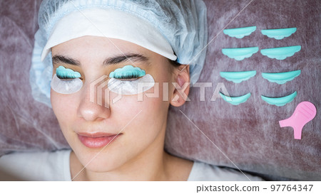 Portrait of a woman in a beauty salon on the procedure of eyelash lamination.  97764347
