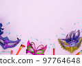 Table top view aerial image of beautiful colorful carnival festival background.Flat lay accessory object the several mask  decor confetti on modern pink paper at home office desk studio.copy space.. 97764648