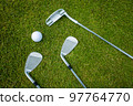 Golf clubs and ball on a green grass, background 97764770