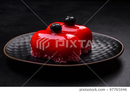 Delicious cheese cakes with red coating made for Valentine's holiday Delicious cheese cakes with red coating made for Valentine's holiday 97765046