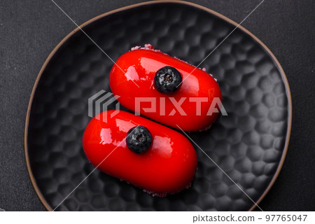 Delicious cheese cakes with red coating made for Valentine's holiday Delicious cheese cakes with red coating made for Valentine's holiday 97765047