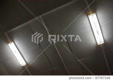 Lamps and smoke detector on the ceiling. Lamps and smoke detector on the ceiling. 97767288