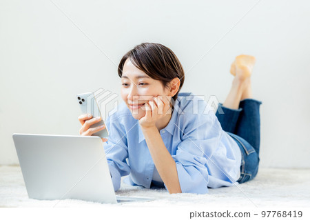 Female smartphone house relaxing Female smartphone house relaxing 97768419