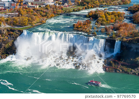 Niagara River American Falls in autumn foliage season. Niagara City Cruise Boat Tour. Niagara Falls City, Ontario, Canada. 97769570