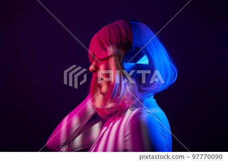 Woman in headphones listening music and enjoing 97770090