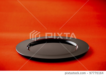 Black lacquerware plate on red chirimen Japanese cloth Image of Japan Black lacquerware plate on red chirimen Japanese cloth Image of Japan 97770164