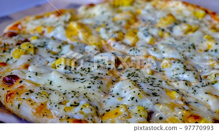 Plenty of corn pizza eaten at eat-in Plenty of corn pizza eaten at eat-in 97770993