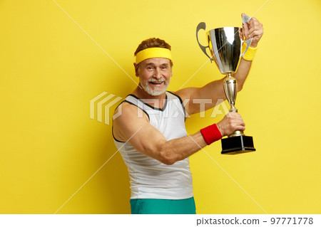 Sportsman award. Mature Man Smiling Happily, Holding Golden Prize Sportsman award. Mature Man Smiling Happily, Holding Golden Prize 97771778
