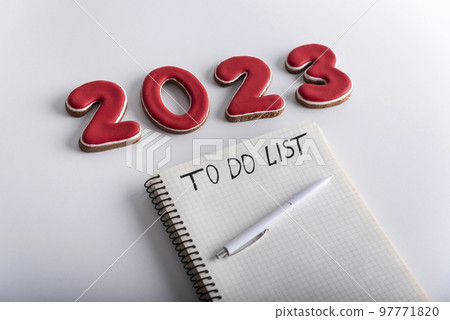 Notepad with inscription TO DO LIST pen and numbers 2023 on white background. Close up. Plans and goals for 2023 97771820