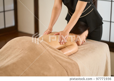 Woman receiving back massage at beauty salon Woman receiving back massage at beauty salon 97771936