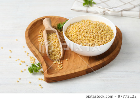 Concept of cooking, uncooked ptitim, on white wooden table 97772122