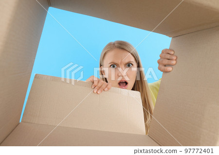 Concept of delivery, young woman look in to box Concept of delivery, young woman look in to box 97772401
