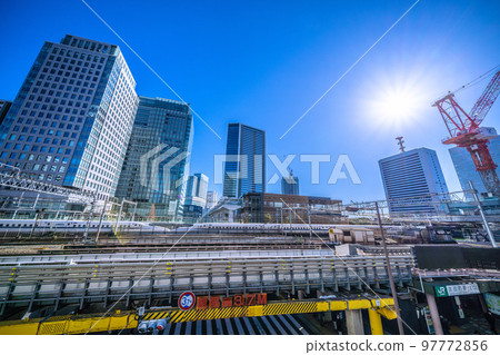 The cityscape of Tokyo in Japan, overlooking Hamamatsucho Station (North Exit), the Shinkansen passing by, skyscrapers, etc. 97772856