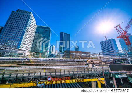 The cityscape of Tokyo in Japan, overlooking Hamamatsucho Station (North Exit), the Shinkansen passing by, skyscrapers, etc. 97772857