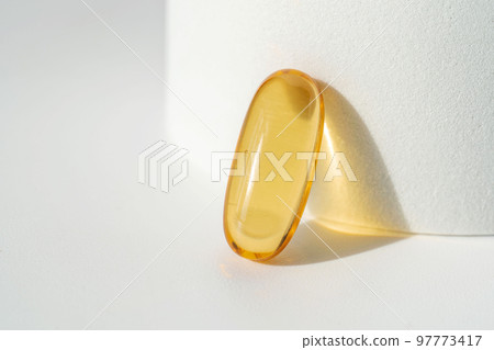 Oil filled capsules on the white background 97773417