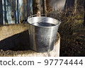 Rural well with a filled bucket of water 97774444