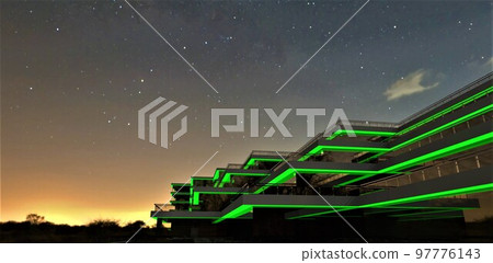 Remarkable design of a futuristic hotel with a green illuminated facade against the backdrop of a starry night sky two hours before dawn. 3d rendering. Remarkable design of a futuristic hotel with a green illuminated facade against the backdrop of a starry night sky two hours before dawn. 3d rendering. 97776143