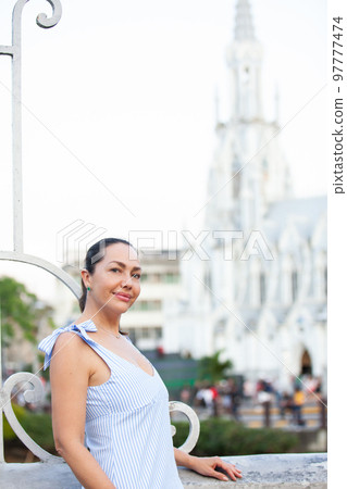 Beautiful tourist woman at the Ortiz Bridge with La Ermita church on background in the city of Cali in Colombia 97777474