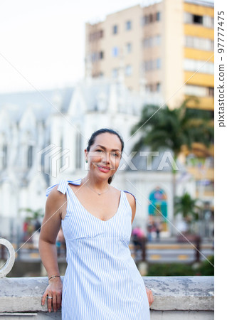 Beautiful tourist woman at the Ortiz Bridge with La Ermita church on background in the city of Cali in Colombia 97777475