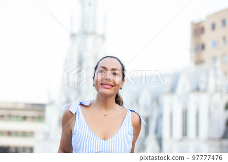 Beautiful tourist woman at the Ortiz Bridge with La Ermita church on background in the city of Cali in Colombia 97777476