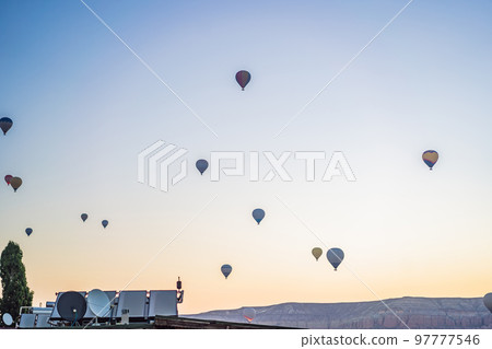 Colorful hot air balloon flying over Cappadocia, Turkey 97777546