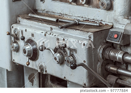 Old lathe for metal processing. Type of metal machine parts in lathe shop at factory. Industrial Old lathe for metal processing. Type of metal machine parts in lathe shop at factory. Industrial 97777884
