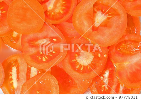 Close-up fresh slices of juicy tomato on white background. Slices of tomato in sparkling water on white background, closeup 97778011