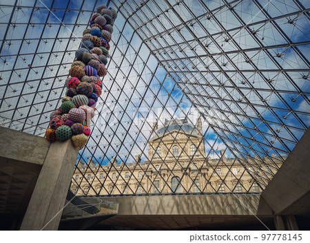 Underneath the Louvre glass pyramid. Beautiful architectural details with an abstract mixture of classical and modern architecture styles Underneath the Louvre glass pyramid. Beautiful architectural details with an abstract mixture of classical and modern architecture styles 97778145