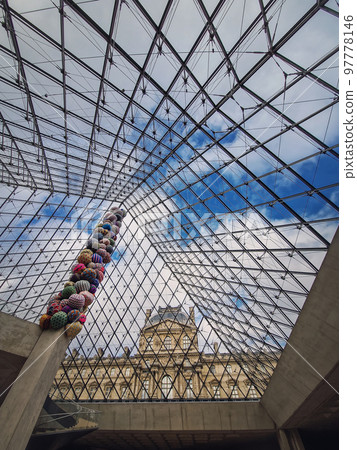 Underneath the Louvre glass pyramid, vertical background. Beautiful architecture details with an abstract mixture of classical and modern styles 97778146