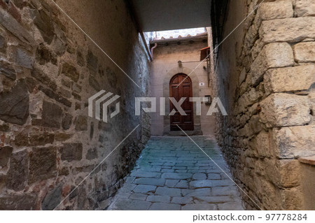 A quiet street of residential buildings in the village of Panzano Tuscany A quiet street of residential buildings in the village of Panzano Tuscany 97778284