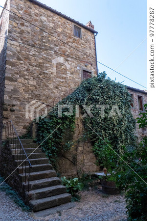 A quiet street of residential buildings in the historic medieval village of Panzano Tuscany A quiet street of residential buildings in the historic medieval village of Panzano Tuscany 97778287