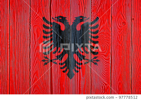 Albania flag painted on old wood plank background. Brushed natural light knotted wooden board texture. Wooden texture background flag of Albania. 97778512