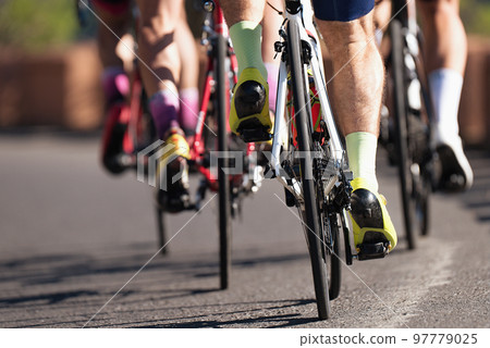 Group of cyclist at professional race, cyclists in a road race stage. Climbing the hill 97779025