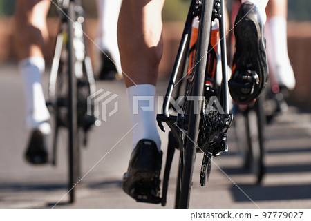 Group of cyclist at professional race, cyclists in a road race stage. Climbing the hill Group of cyclist at professional race, cyclists in a road race stage. Climbing the hill 97779027