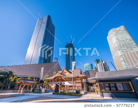 The cityscape of Tokyo, Japan, with a view of Hachiman Shrine and the skyscrapers of the Toranomon-Azabudai project 97779237
