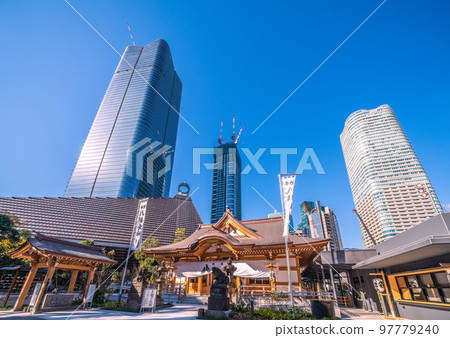 The cityscape of Tokyo, Japan, with a view of Hachiman Shrine and the skyscrapers of the Toranomon-Azabudai project 97779240