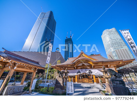 The cityscape of Tokyo, Japan, with a view of Hachiman Shrine and the skyscrapers of the Toranomon-Azabudai project 97779244