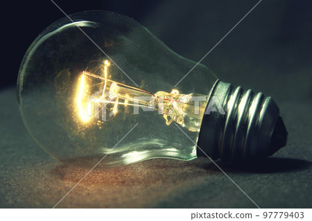 the light bulb glows without wires on the table. 97779403