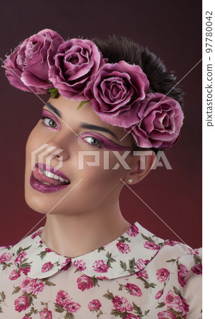 Close-up portrait girl with a pink lipstick and shadows for eyes and a wreath on his head Close-up portrait girl with a pink lipstick and shadows for eyes and a wreath on his head 97780042