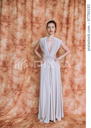 Nice woman with elegant Hairstyle. Brunette Fashion Model Woman wearing Summer Prom long maxi transformer Dress 97780285