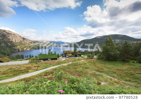 Beautiful landscape of Norway homes with green roofs and, mountainous terrain and reservoirs Beautiful landscape of Norway homes with green roofs and, mountainous terrain and reservoirs 97780528