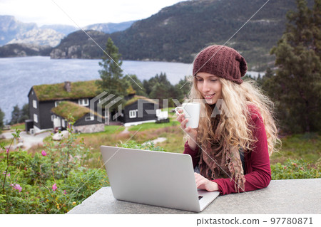 Freelance girl working on laptop in nature and beautiful landscapes Freelance girl working on laptop in nature and beautiful landscapes 97780871