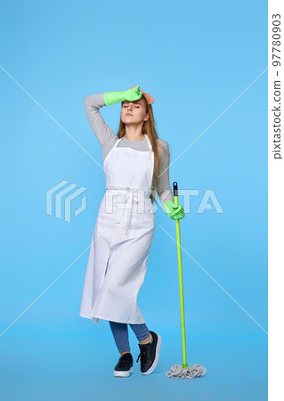 woman in rubber gloves and cleaner apron washing floor with mop woman in rubber gloves and cleaner apron washing floor with mop 97780903