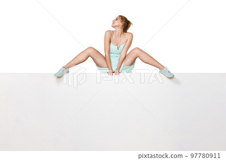 Beautiful woman in dress sitting on white banner. Beautiful woman in dress sitting on white banner. 97780911