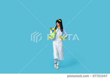 woman in rubber gloves and cleaner apron with cleaning supplies 97781047