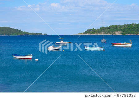 Boat parking in summer. Marina and boats moored in blue bay in Montenegro. Picturesque bay, travels. Sunny summer day. 97781058