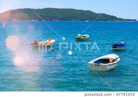 Boat parking in summer. Marina and boats moored in blue bay in Montenegro. Picturesque bay. Sunny summer day. 97781059