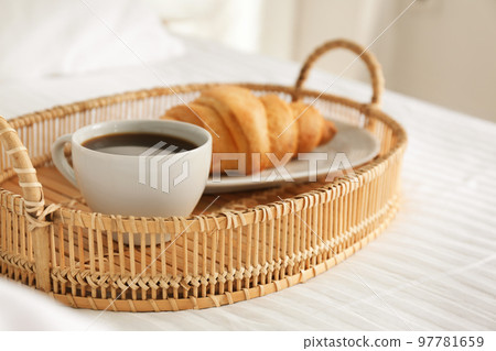 Tray with tasty breakfast on bed. Cozy morning Tray with tasty breakfast on bed. Cozy morning 97781659