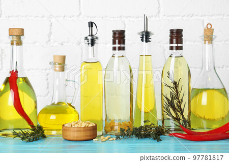 Different cooking oils on blue wooden table 97781817
